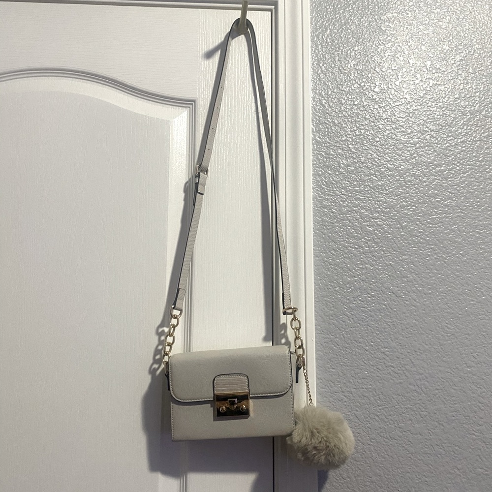 Little cute Aldo cross bag. With a cute fuzzy ball